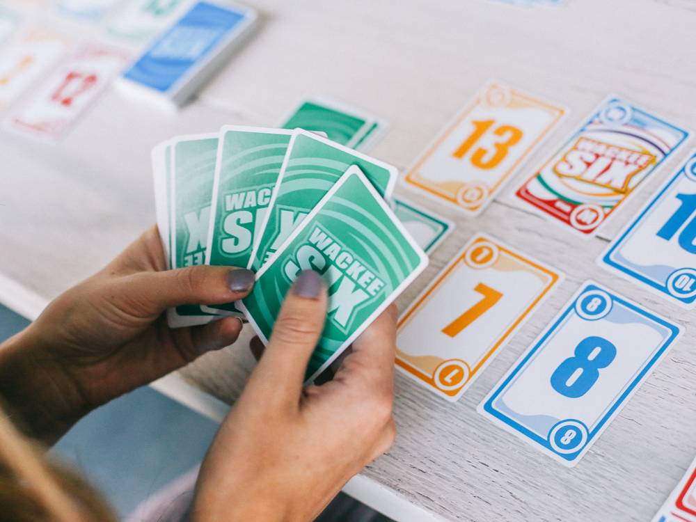 A hand of green cards over the table